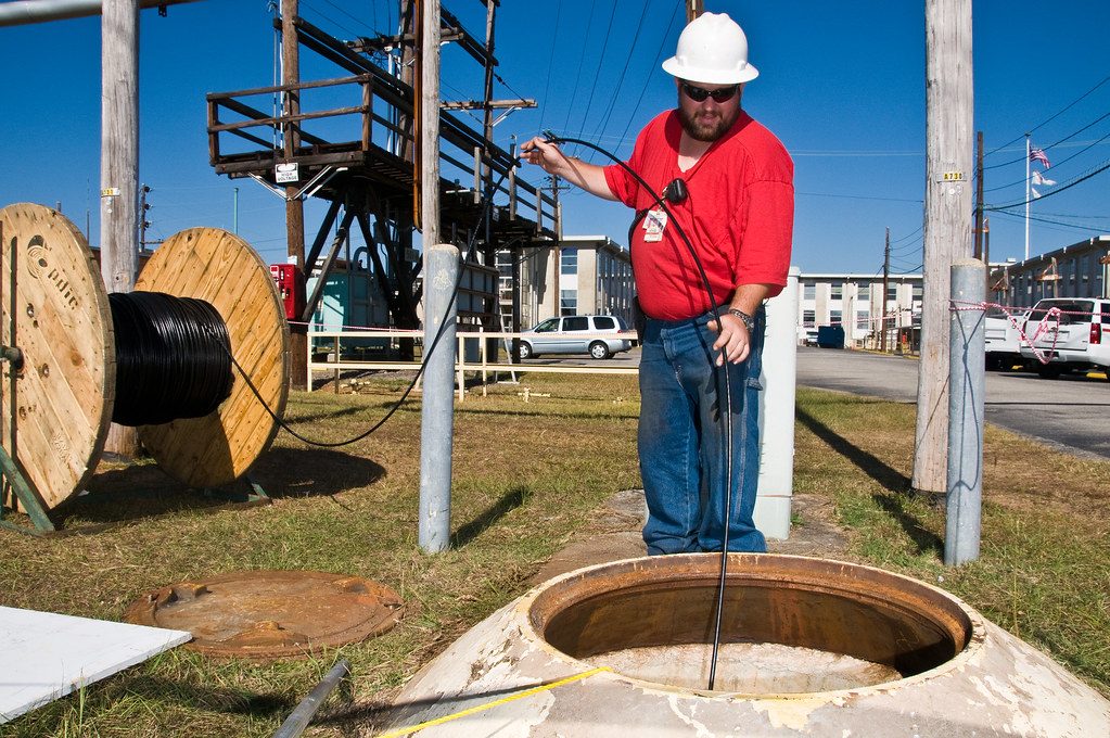 Técnico trabajando en una arqueta de fibra